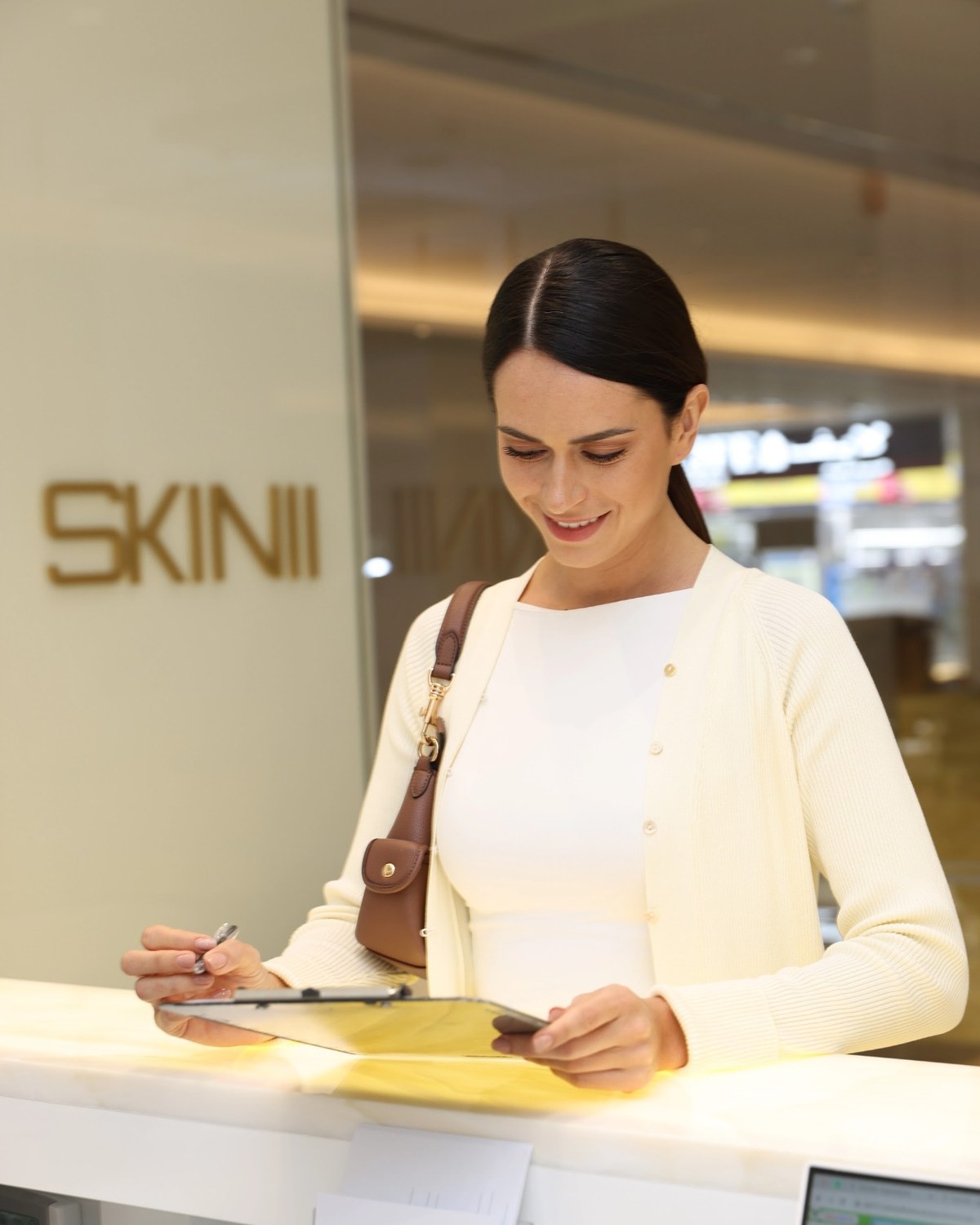 Patient completing registration at SKINIII Aesthetics Clinic